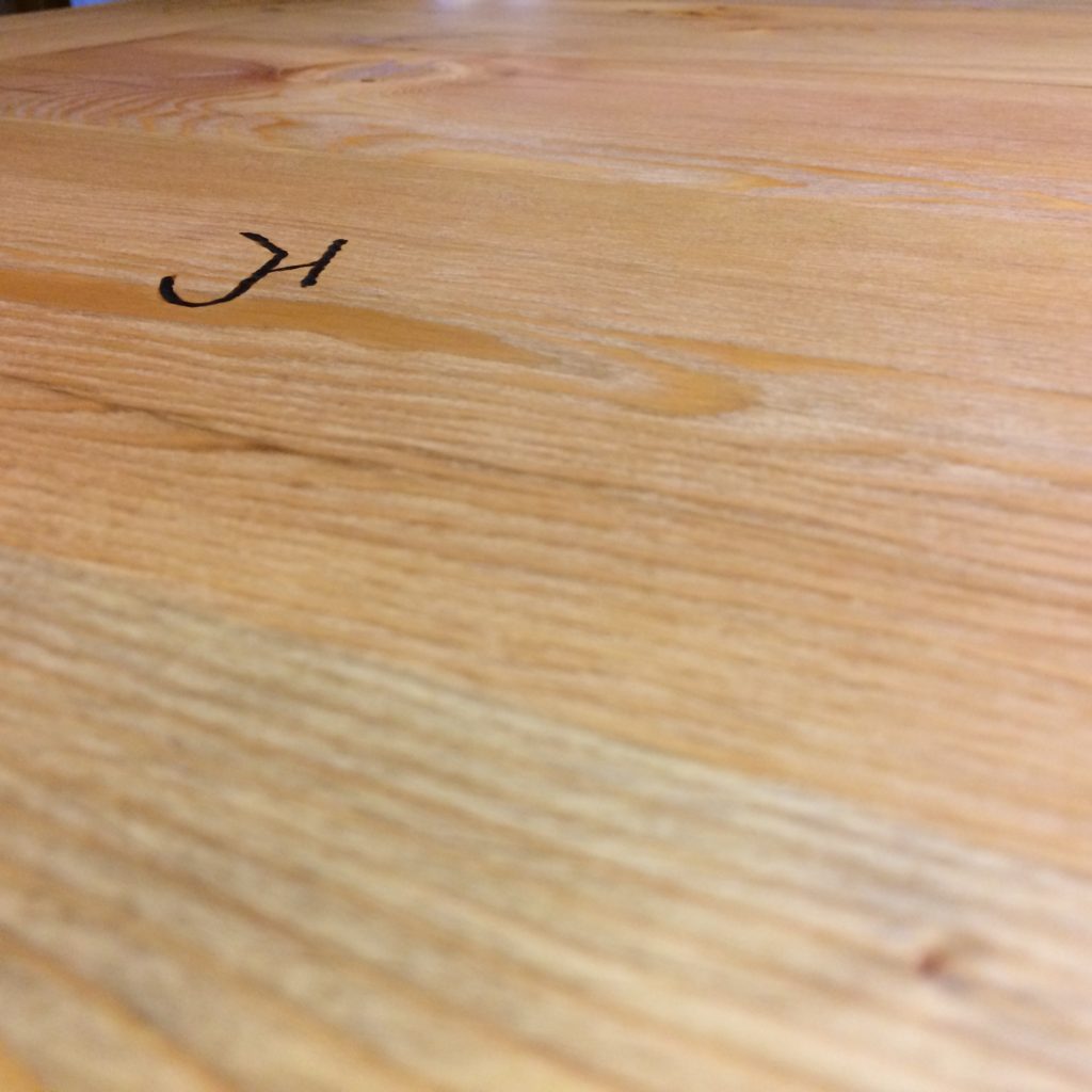 Henningsen Woodshop brand underneath a tabletop